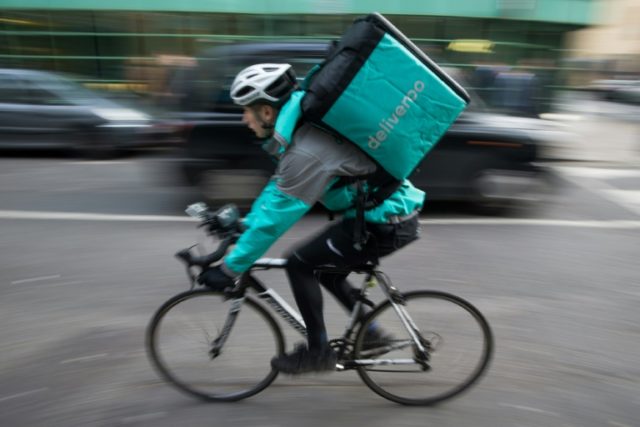 Restaurant food delivery company Deliveroo employee, Billy Shannon bikes at work in north