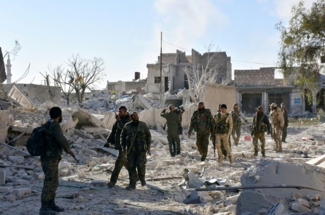 Syrian pro-government forces inspect an area on November 27, 2016 in the Masaken Hanano di