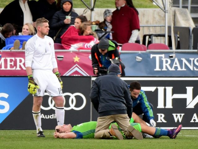 Jordan Morris of Seattle Sounders receives attention from staff in front of goaltender Zac