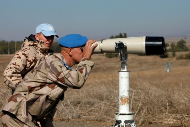 A UN officer monitors the Israel-Syria border in the Israeli-annexed Golan Heights, on Nov
