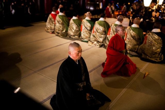 Japanese Buddhist monk, Kazuki Yazawa bows his head in prayer five times a day - very few
