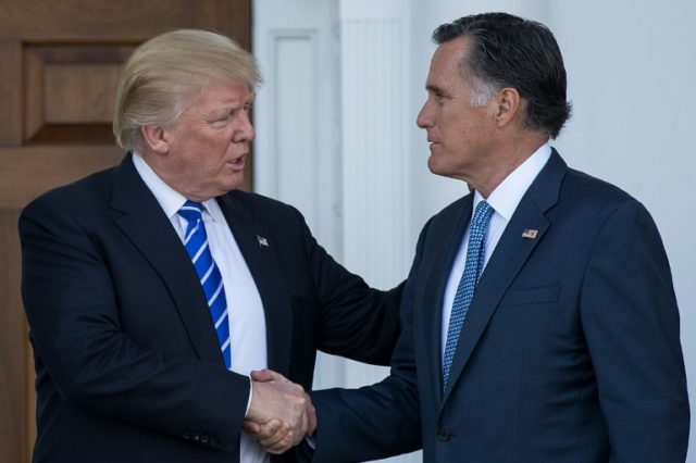 President-elect Donald Trump (L) shakes hands with Mitt Romney after their meeting at Trum