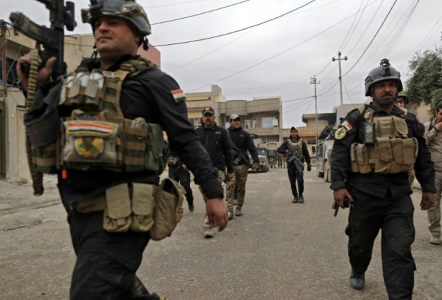 Soldiers from the Iraqi special forces secure a street during an operation against Islamic