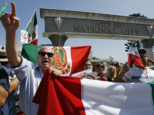 Immigrants rights activists chant during a sanctuary city rally held in National City, Calif., Saturday, Sept. 30, 2006. National City Mayor Nick Inzunza is proposing that the city become a sanctuary for illegal immigrants. A counter protest organized by the Minuteman Project drew over a hundred people opposed to the …