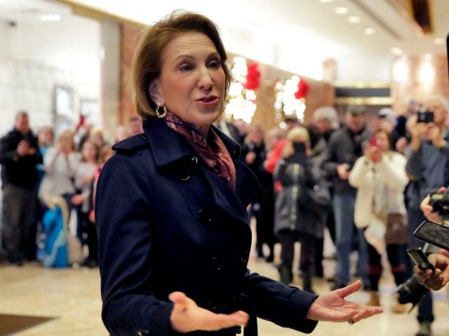 Carly Fiorina stops to talk with the press in the lobby of Trump Tower, after her meeting