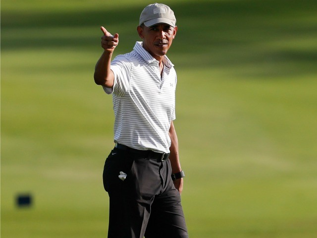 President Barack Obama walks across the 18th green at Kapolei Golf Club, in Kapolei, Hawaii, Wednesday, Dec. 21, 2016. ()