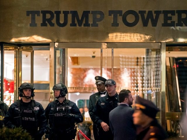 New York firefighters, police officers and others stand outside Trump Tower lobby in New Y