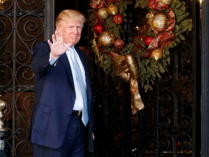 President-elect Donald Trump stands at the entrance of Mar-a-Lago and waves to reporters after meeting with Carlyle Group co-founder and co-CEO David Rubenstein, Wednesday, Dec. 28, 2016, in Palm Beach, Fla. (