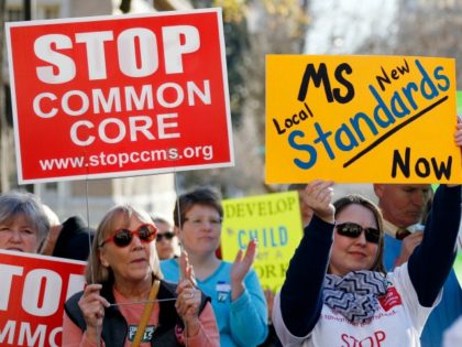 FILE - In this Jan. 6, 2015 file photo, Common Core opponents wave signs and cheer at a rally opposing Mississippi's continued use of the Common Core academic standards on the steps of the Capitol in Jackson, Miss. Results for some of the states that participated in Common Core-aligned testing …