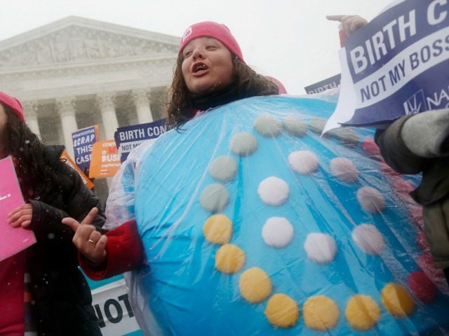 In this March 25, 2015, file photo, Margot Riphagen, of New Orleans, wears a birth control pills costume as she protests in front of the Supreme Court in Washington.