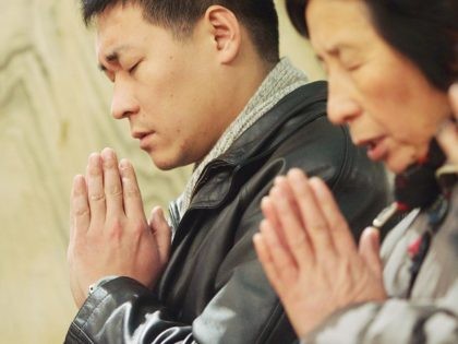 BEIJING, CHINA - DECEMBER 24: Catholics pray at Christmas Mass at a church on December 24,