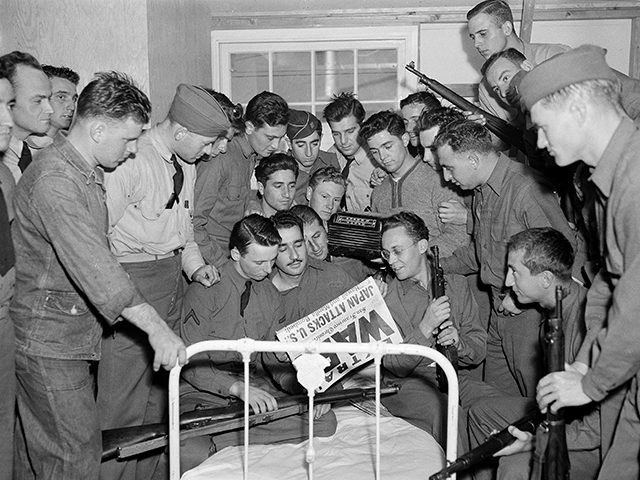 U.S. soldiers at the Presidio in San Francisco gather around the bed of one of their comra