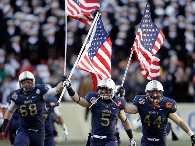 John Dowd #68, Brian Blick #5, and Max Blue #44 of the Navy Midshipmen carry the American