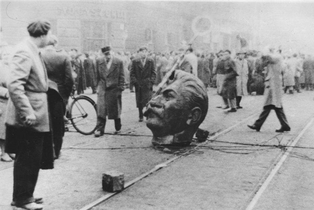 A sculpted head of Stalin, knocked off its statue during an anti-Russian demonstration, lies in the middle of a road in Budapest. (Photo by Keystone/Getty Images)