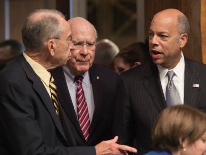Homeland Security Secretary Jeh Johnson speaks with Senate Judiciary Committee chairman Senator Chuck Grassley of Iowa (L) and Ranking Member Senator Patrick Leahy of Vermont as he arrives to testify at a hearing on Oversight of the Department of Homeland Security on Capitol Hill in Washington, DC, on June 30, …