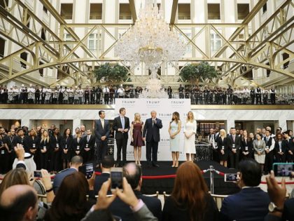 Republican presidential nominee Donald Trump (C) and his family (L-R) son Donald Trump Jr, son Eric Trump, wife Melania Trump and daughters Tiffany Trump and Ivanka Trump prepare to cut the ribbon at the new Trump International Hotel October 26, 2016 in Washington, DC. The hotel, built inside the historic …