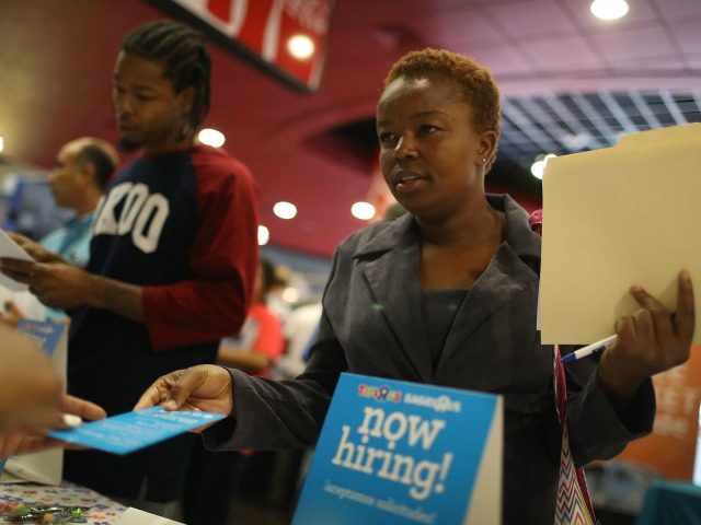 Melissa Thermidor speaks to a job recruiter for Toys'R'Us during the JobNewsUSA job fair at the BB&T Center on November 15, 2016 in Sunrise, Florida.