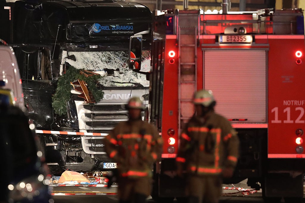 Security and rescue workers tend to the area after a lorry truck ploughed through a Christmas market on December 19, 2016 in Berlin, Germany. Several people have died while dozens have been injured as police investigate the attack at a market outside the Kaiser Wilhelm Memorial Church on the Kurfuerstendamm and whether it is linked to a terrorist plot.
