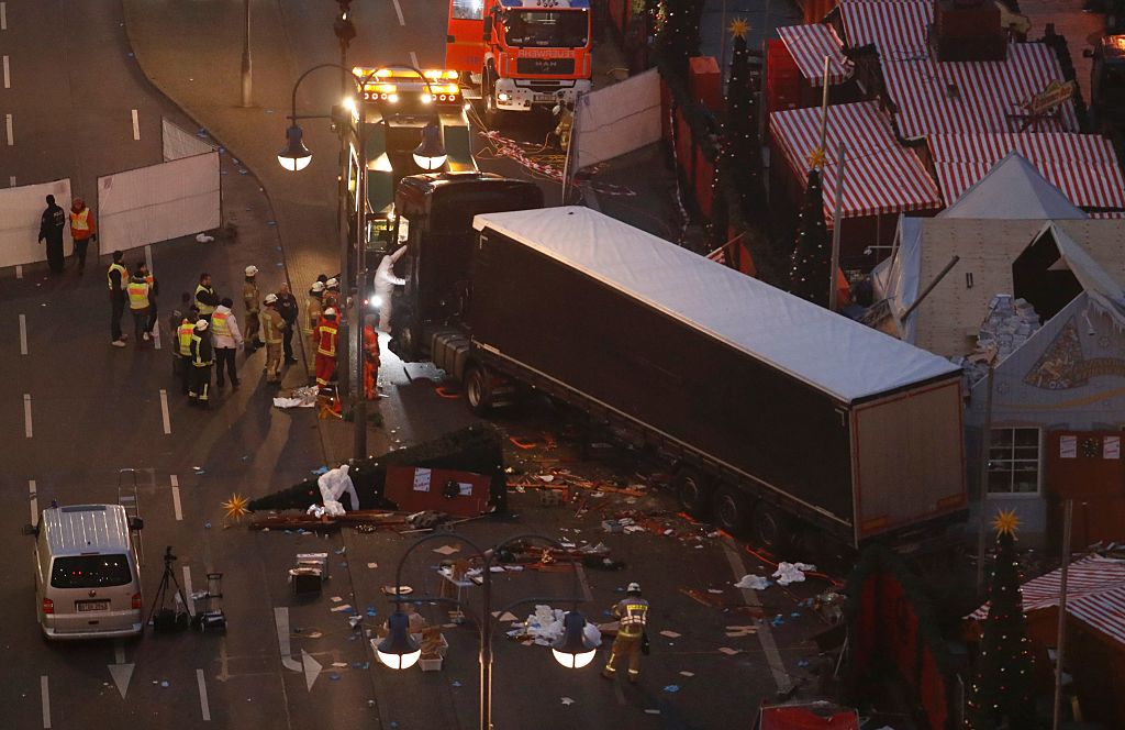 Forensic experts examine the scene around a truck that crashed into a Christmas market on December 20, 2016 in Berlin. German police said they were treating as "a probable terrorist attack" the killing of 12 people when the speeding lorry cut a bloody swath through the packed Berlin Christmas market. / AFP / Odd ANDERSEN (Photo credit should read ODD ANDERSEN/AFP/Getty Images)