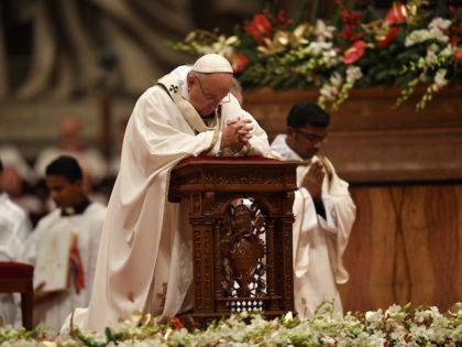 Pope Francis prays during a mass on Christmas eve marking the birth of Jesus Christ on Dec