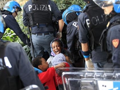Italian police officers surround a family of migrants during an operation to remove them from the Italian-French border in the Italian city of Ventimiglia on June, 16, 2015. Italy and France engaged in a war of words as a standoff over hundreds of Africans offered a graphic illustration of Europe's …