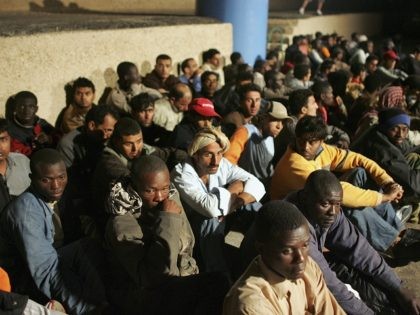 LAMPEDUSA, ITALY - JUNE 13: Illegal immigrants wait to be sent to a temporary holding cent