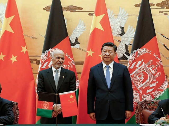 Chinese President Xi Jinping, center right, and Afghan President Ashraf Ghani Ahmadzai, center left, attend the signing ceremony at the Great Hall of the People Tuesday, Oct. 28, 2014 in Beijing, China. Afghanistan's new president is visiting Beijing to seek Chinese help in rebuilding his country and boosting regional stability. (AP Photo/Lintao Zhang, Pool)