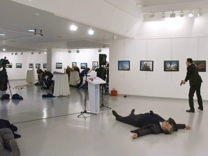 This picture taken on December 19, 2016 shows Andrei Karlov (2ndR), the Russian ambassador to Ankara, lying on the floor after being shot by Mevlut Mert Altintas (R) during an attack during a public event in Ankara. A gunman crying 'Aleppo' and 'revenge' shot Karlov while he was visiting an …