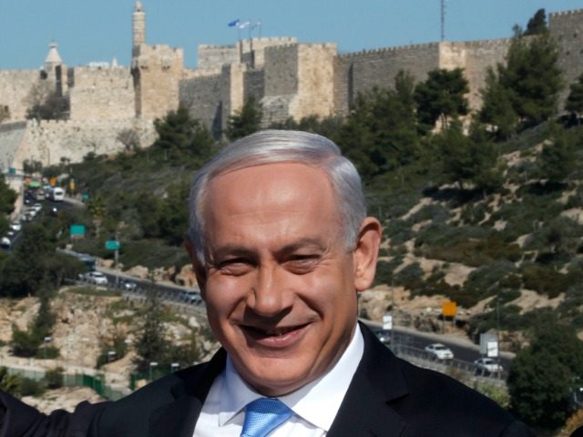 Backdropped by Jerusalem's Old City walls, Israeli Prime Minister Benjamin Netanyahu speaks to the press during a visit to the Begin Heritage center on January 21, 2013. With less than 24 hours until Israelis vote in general elections, party leaders were campaigning down to the wire ahead of a ballot …
