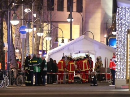 Security and rescue workers tend to the scene after a lorry truck ploughed through a Christmas market on December 19, 2016 in Berlin, Germany. At least two people have died as police investigate the attack and whether it is linked to a terrorist plot.