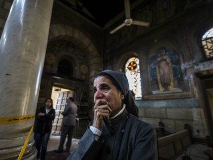 A nun reacts as Egyptian security forces (unseen) inspect the scene of a bomb explosion at the Saint Peter and Saint Paul Coptic Orthodox Church on December 11, 2016, in Cairo's Abbasiya neighbourhood. The blast killed at least 25 worshippers during Sunday mass inside the Cairo church near the seat …