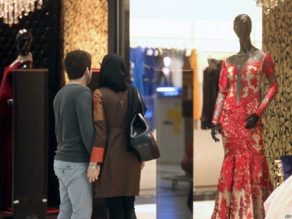An Iranian couple look at a window display of a shop selling women's clothes at the Laleh Park shopping center in Tabriz in Iran's northwestern East-Azerbaijan province on October 15, 2014. AFP PHOTO /ATTA KENARE (Photo credit should read ATTA KENARE/AFP/Getty Images)