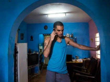 Danilo Maldonado, better known as El Sexto, speaks on a mobile phone in the living room of