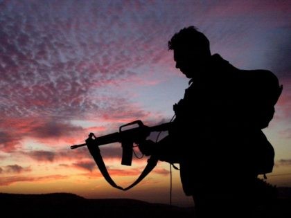 In this photo distributed by the IDF February 8, 2003, an Israeli army paratrooper stands guard at sunrise during a brigade-wide exercise in northern Israel. For the part week, the elite paratroopers brigade has held a large-scale exercise as it takes a break from more than two years of intensive …
