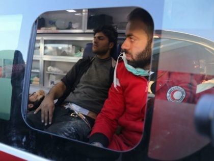 Wounded Syrian men who were evacuated from rebel-held neighbourhoods in the embattled city