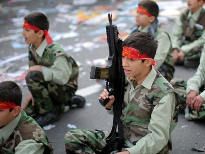 Iranian Basij militia schoolboys take part in a rally outside the former US embassy in Teh