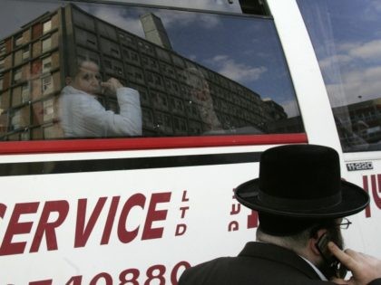 A woman looks out of the window of a bus as Jerusalem's Hadassah hospital is reflected on the glass 09 January 2006. Israeli Prime Minister Ariel Sharon was breathing unassisted today while being gradually awoken from a deep coma so doctors can assess the extent of damage to his brain …