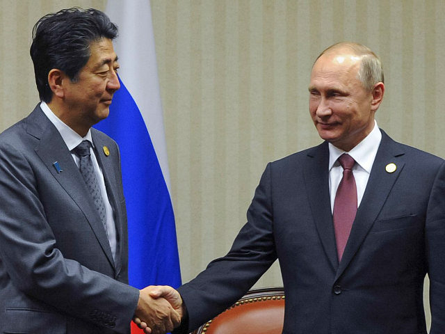 LIMA, PERU - NOVEMBER 19, 2016: Japan's Prime Minister Shinzo Abe (L) and Russia's Preside