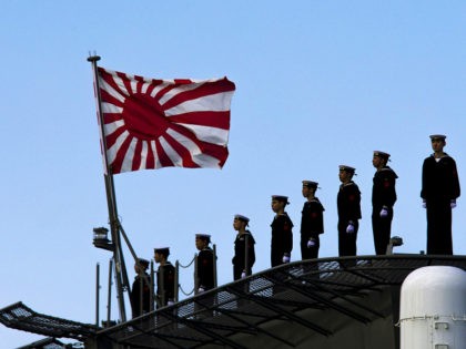 Sailors stand on the deck of the Izumo warship as it departs from the harbor of the Japan United Marine shipyard in Yokohama, south of Tokyo. March 25, 2015. REUTERS/Thomas Peter