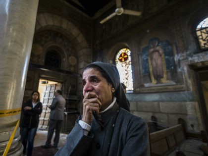 A nun reacts as Egyptian security forces (unseen) inspect the scene of a bomb explosion at the Saint Peter and Saint Paul Coptic Orthodox Church on December 11, 2016, in Cairo's Abbasiya neighbourhood. The blast killed at least 25 worshippers during Sunday mass inside the Cairo church near the seat …