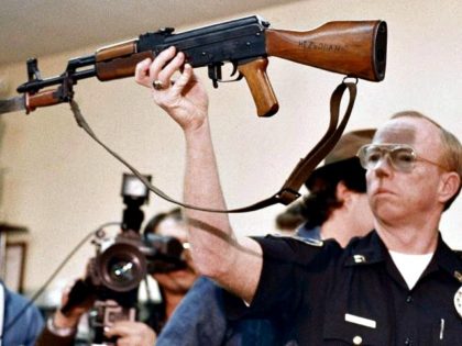 officer holds long gun-AP