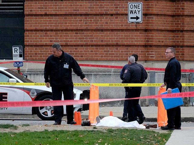 Police cover the body of a suspect outside Watts Hall on the campus of Ohio State Universi