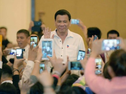 Philippine President Rodrigo Duterte greets members of the Filipino community as he arrive