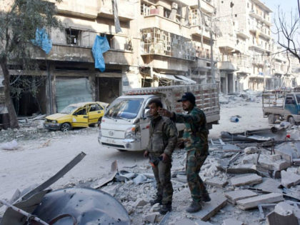 Syrian pro-government forces stand on a street in al-Maadi district of eastern Aleppo on December 11, 2016 after they retook a large part of it from rebel fighters. Thousands of civilians poured out of rebel areas of Aleppo as Syria's army pushed to take the last remnants of opposition-held territory …
