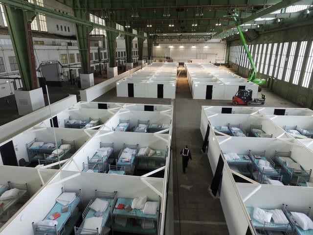 BERLIN, GERMANY - FEBRUARY 11: In this aerial view cubicles furnished with bunk beds stand ready to accommodate refugees and asylum applicants in Hangar 6 of former Tempelhof Airport on February 11, 2016 in Berlin, Germany. Tempelhof, once an airport in the city center and first built in the 1930s, …