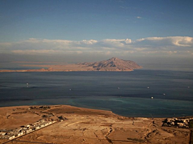 A picture taken on January 14, 2014 through the window of an airplane shows the Red Sea's Tiran (foreground) and the Sanafir (background) islands in the Strait of Tiran between Egypt's Sinai Peninsula and Saudi Arabia. Saudi King Salman on April 11, 2016 wrapped up a landmark five-day visit to …