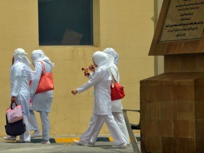 Asian staff nurses walk towards the King Fahad hospital in the city of Hofuf, 370 kms East of the Saudi capital Riyadh, on June 16, 2013. Four people have died from the MERS virus in Saudi Arabia, bringing the death toll from the SARS-like virus in the kingdom to 32, …