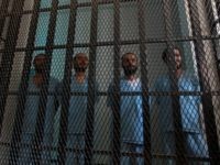 Prisoners stand in their holding cell at the court room of a state security court during their trial on March 2, 2014 in the Yemeni capital Sanaa. The defendants, two of them being tried in absentia, are charged with forming part -- between 2011 and 2013 -- of 'an armed …