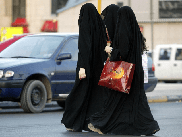 Saudi women walk out of a shopping mall as they wait for their driver to pick them up in R