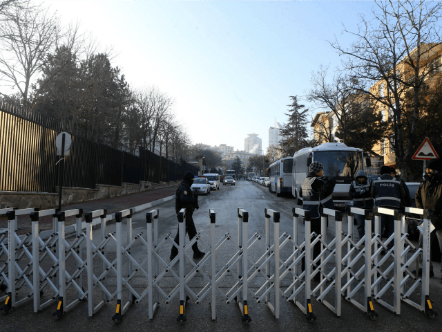 Turkish police officers stand guard outside the Russian Embassy in Ankara on December 20,